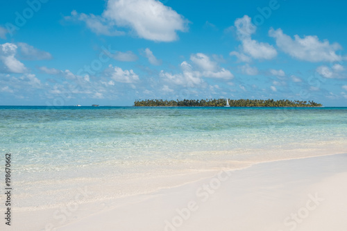 white sand beach  turquoise water and palm tree island