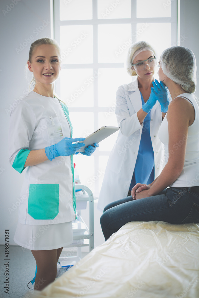 Beautiful woman face near doctor with syringe Beautiful woman face near doctor with syringe