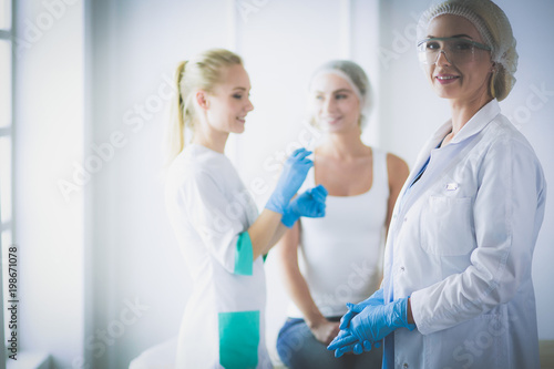 Beautiful woman face near doctor with syringe