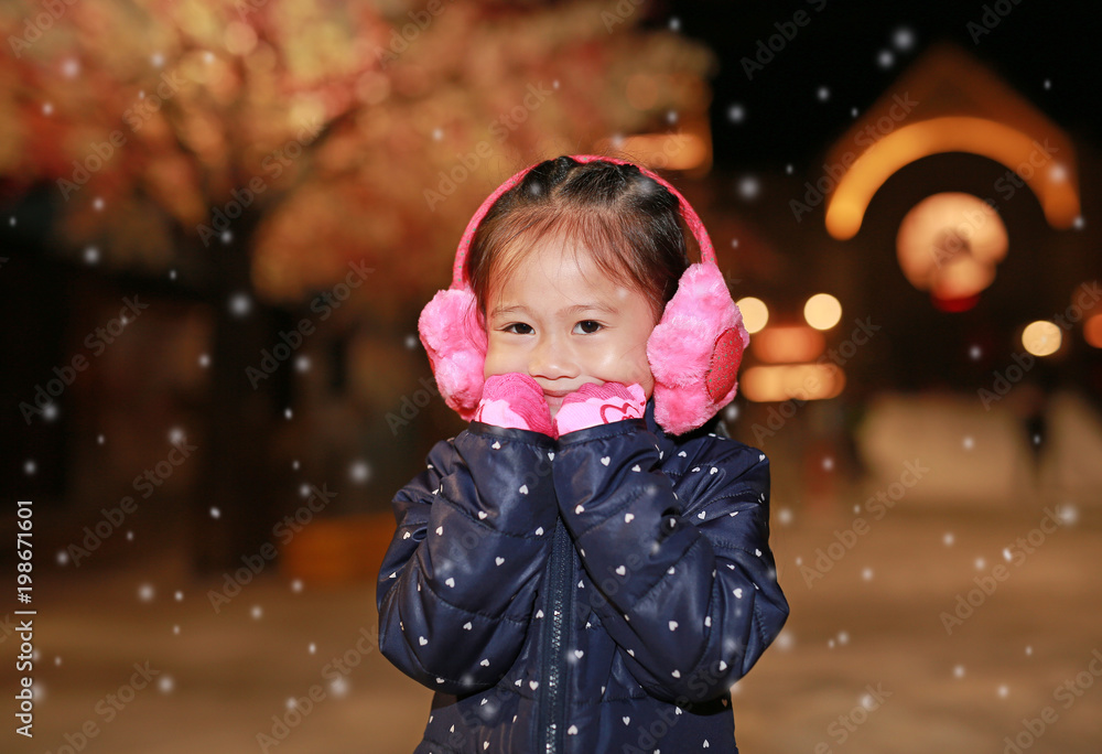 Fototapeta premium Happy asian girl wearing jacket stand in snow.