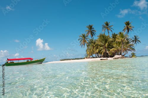 small island ,boat and palm trees, San Blas Islands