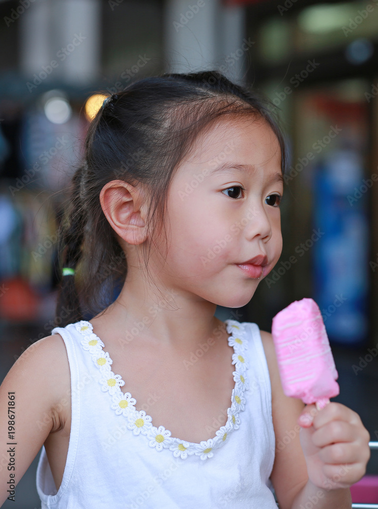 Little asian child girl eating ice-cream.
Little asian child girl eating ice-cream.