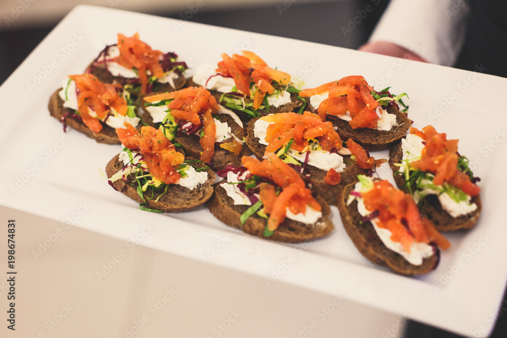 Beautifully decorated catering banquet table with different food snacks and appetizers on corporate christmas birthday party event or wedding celebration
Beautifully decorated catering banquet table with different food snacks and appetizers on corporate christmas birthday party event or wedding celebration