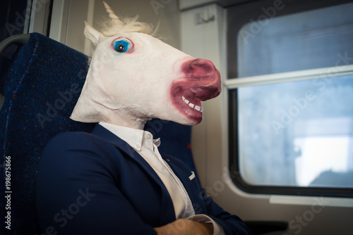 Cuadro en lienzo Unusual passenger in elegant suit sits alone inside the train and ready to travel