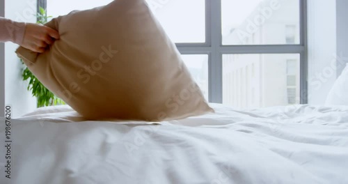 Woman holding pillow in bedroom  photo