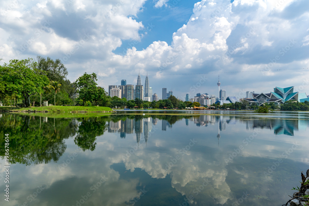 KUALA LUMPUR, MALAYSIA - 30th MARCH 2018; Cloudy and sunny view of Kuala Lumpur from Lake Titiwangsa.The lake is located just beside the busy Jalan Tun Razak in the heart of Kuala Lumpur, Malaysia.