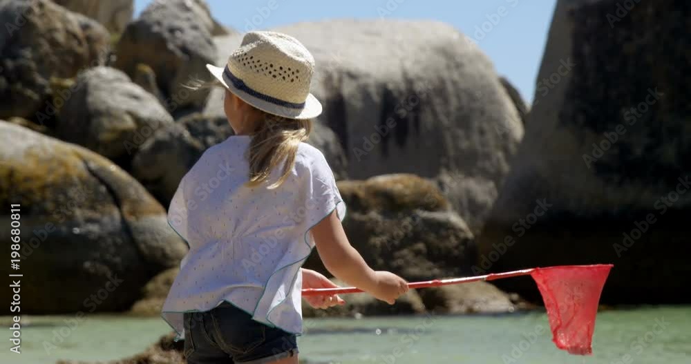 Girl fishing with net at beach Girl fishing with net at beach