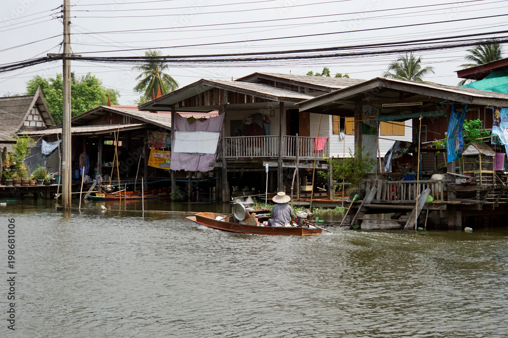 In view of the houses along the river in Thailand. The boat ride over to sell to the people who live along the canal.