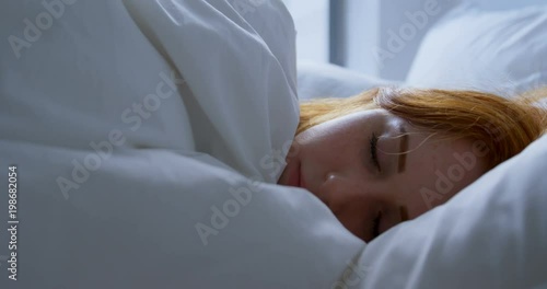 Woman sleeping in bedroom at home photo