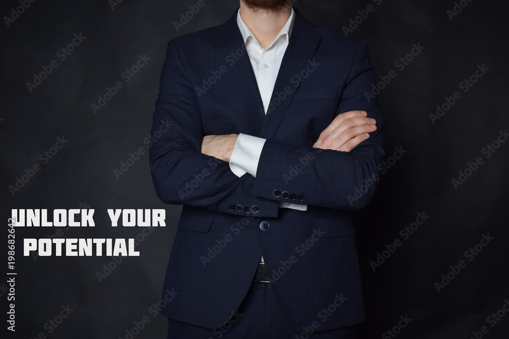 A businessman shows an inscription:UNLOCK YOUR POTENTIAL