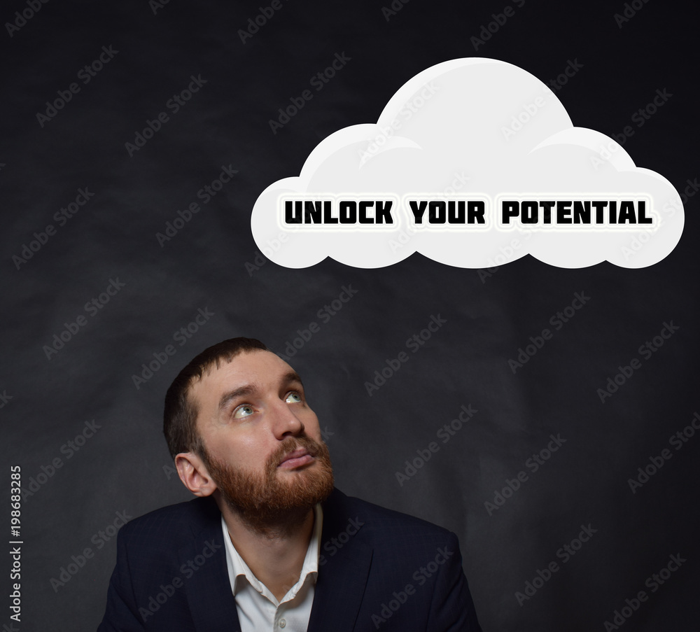 Above the businessman hangs a cloud with the inscription:UNLOCK YOUR POTENTIAL Above the businessman hangs a cloud with the inscription:UNLOCK YOUR POTENTIAL