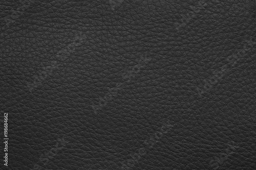 Texture of artificial leather surface. Black background or leatherette backdrop for design.