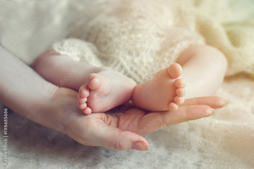 Baby feet in mother hands. Mom and her Child. Happy Family concept. Beautiful conceptual image of Maternity Baby feet in mother hands. Mom and her Child. Happy Family concept. Beautiful conceptual image of Maternity