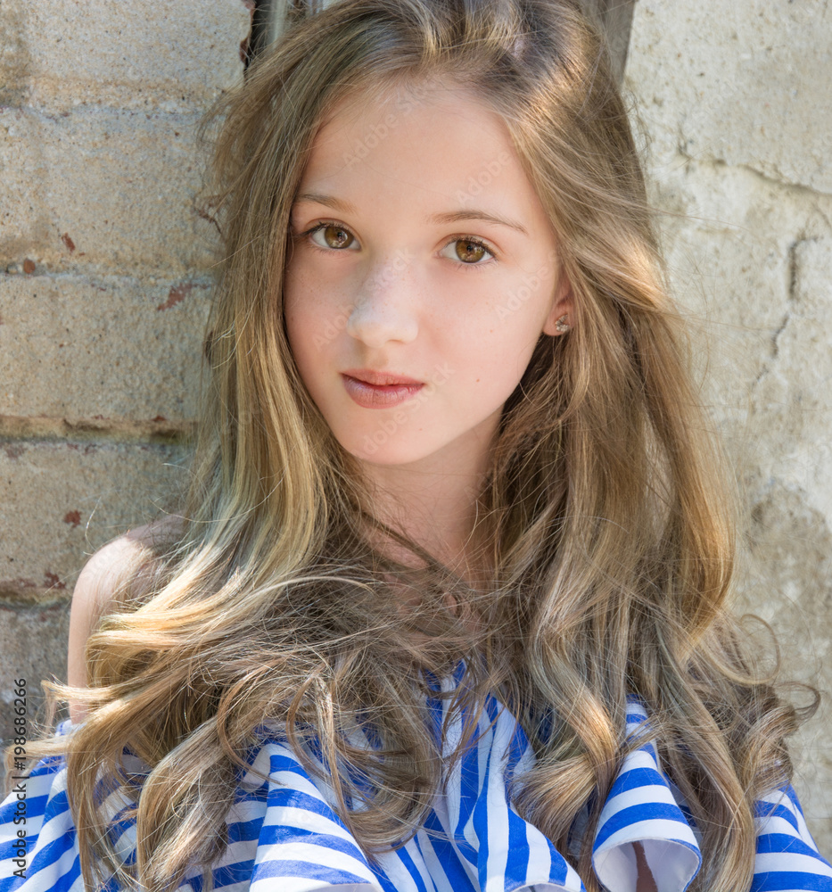 a young girl is sitting in the window opening, in the devastated building in the Park, a young girl is sitting in the window opening, in the devastated building in the Park,