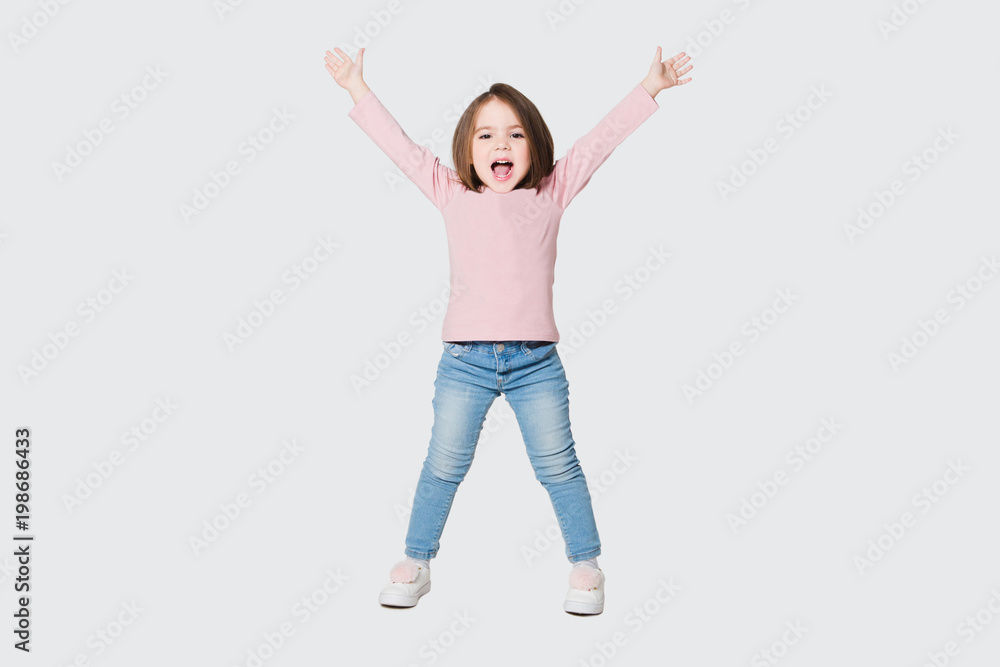 Cute girl raise hands up on a white background. Cute girl raise hands up on a white background.