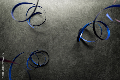 Blue Wrapping Ribbon Hanging on Black Surface Background