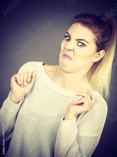 Disgusted woman having funny face expression photo