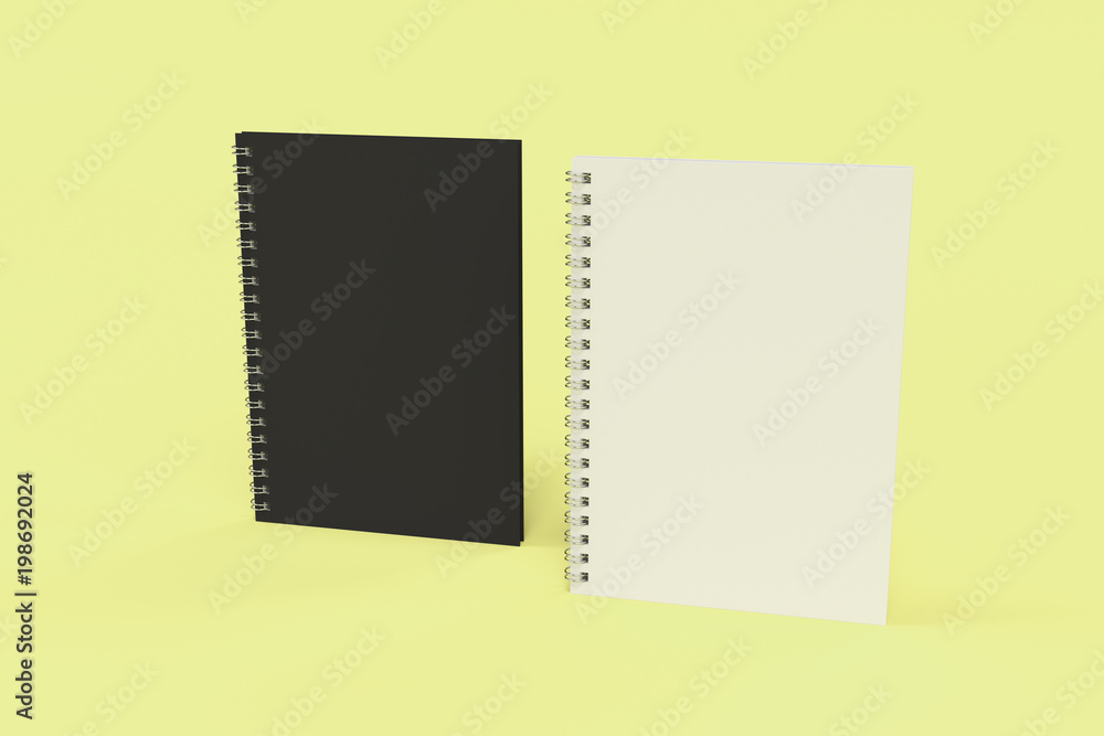 Two notebooks with spiral bound on yellow background Two notebooks with spiral bound on yellow background
