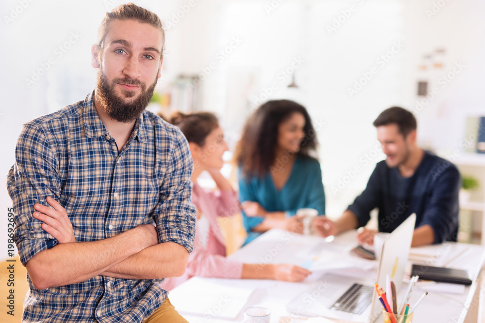 At office. Portrait of a young man looking at the camera. In the At office. Portrait of a young man looking at the camera. In the