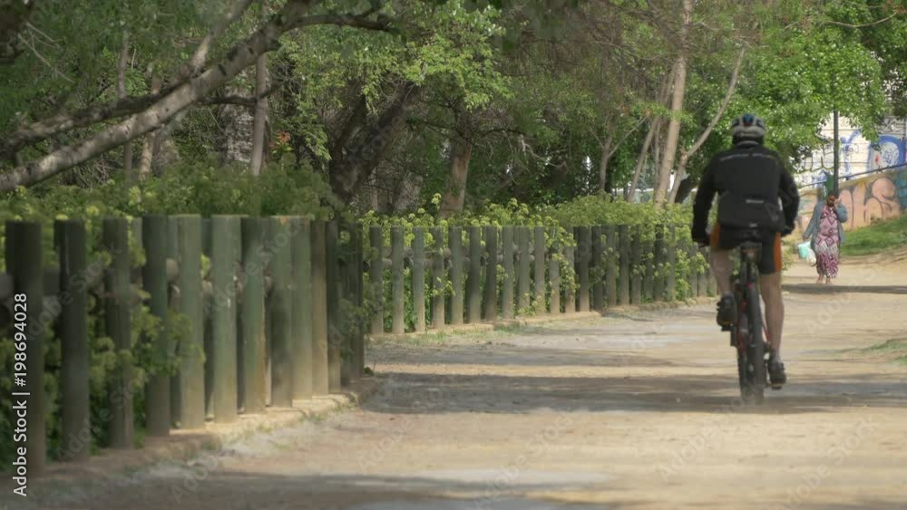 Riding a bike in a park Riding a bike in a park