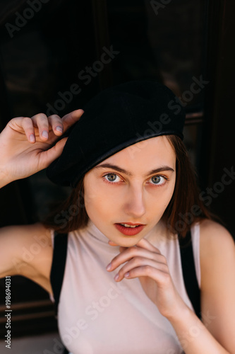 beautiful features of the face of a young girl in black beret th