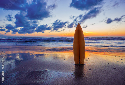 surfboard on the beach in sea shore at sunset time