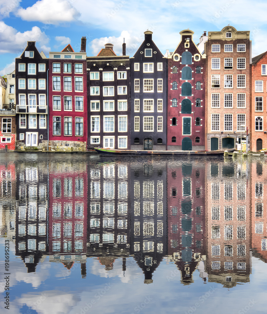 Amsterdam architecture with reflection in Damrak canal, Netherlands