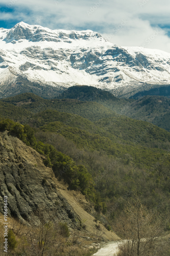 Tzoumerka mountain peaks in spring time, snow on the top, epirus greece , for travel background Tzoumerka mountain peaks in spring time, snow on the top, epirus greece , for travel background
