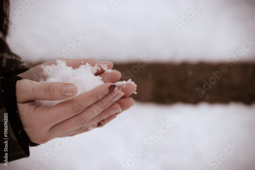 Close up of holding the snow in woman's hands, winter concept with copy space (Vintage tone)