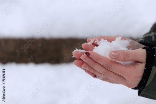 Close up of holding the snow in woman's hands, winter concept with copy space