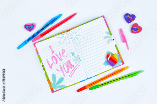 Notebook with stationery on a white table