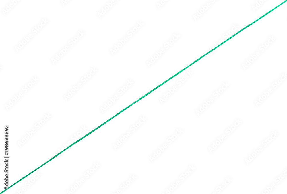 Green thread on a white background diagonally. Green thread on a white background diagonally.
