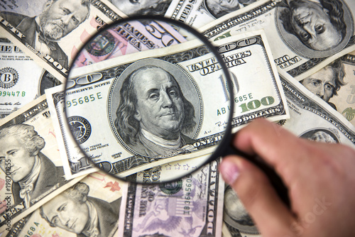 Dollar with magnifier. Magnifying glass and money. Business concept background.