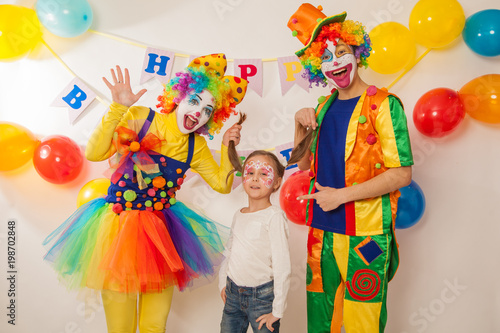 clown boy and clown girl on birthday girl. Party for children. Clowns amuse the child