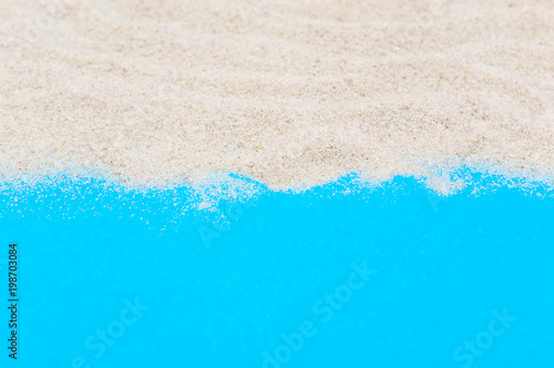 Sand on blue background. Copy space for text.