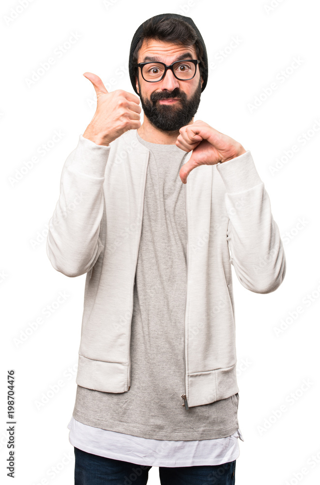 Hipster man making good-bad sign on white background Hipster man making good-bad sign on white background