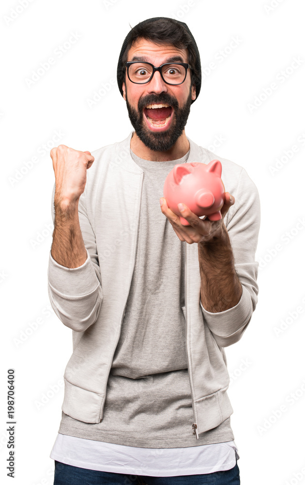 Happy Hipster man holding a piggybank on white background Happy Hipster man holding a piggybank on white background