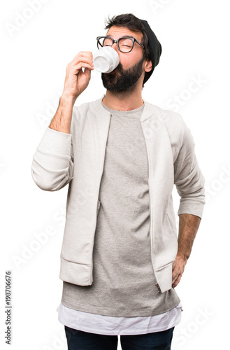 Hipster man holding a cup of coffee on white background