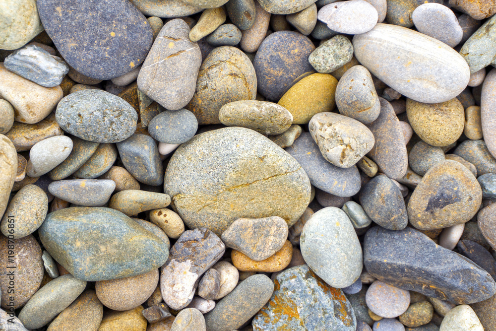 Smooth round pebbles sea texture background. Pebble on a beach. Gravel stone seashore. Smooth round pebbles sea texture background. Pebble on a beach. Gravel stone seashore.