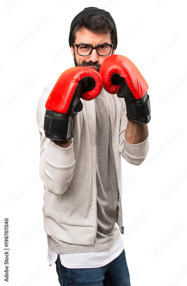 Hipster man with boxing gloves on white background