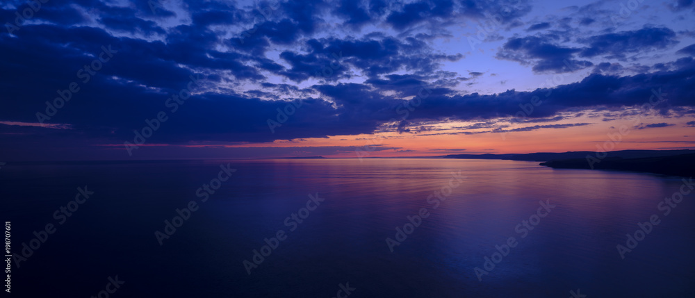 Spring sunset over Jurassic coast from St Alban's of St Adhelm's Head, Dorset, UK