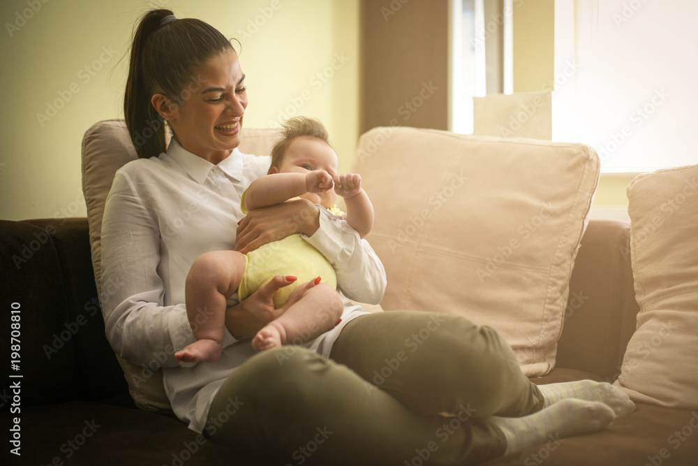 Young mother with her baby girl at home. Young mother with her baby girl at home.