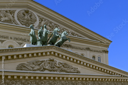 Fragment of the Fronton of the Moscow Big Theater with a quadriga of Apollos and a two-headed eagle on a sunny day.( Bolshoi Theater)  Moscow.