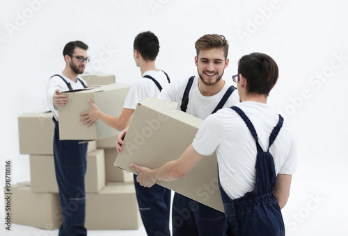 Portrait of movers holding box smiling isolated on white backgro
