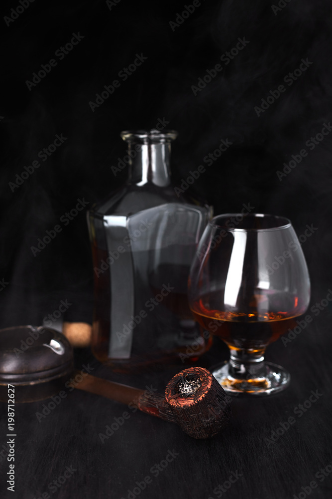 Glass of whiskey with smoking cigar. Glass of whiskey with smoking cigar.