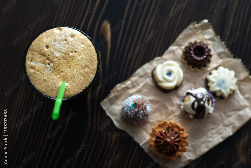 Coffee and small colorful sweet cakes Coffee and small colorful sweet cakes