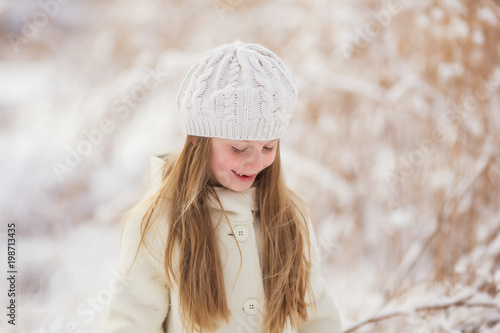 portrait of a girl walking in the winter outdoors. children outdoor