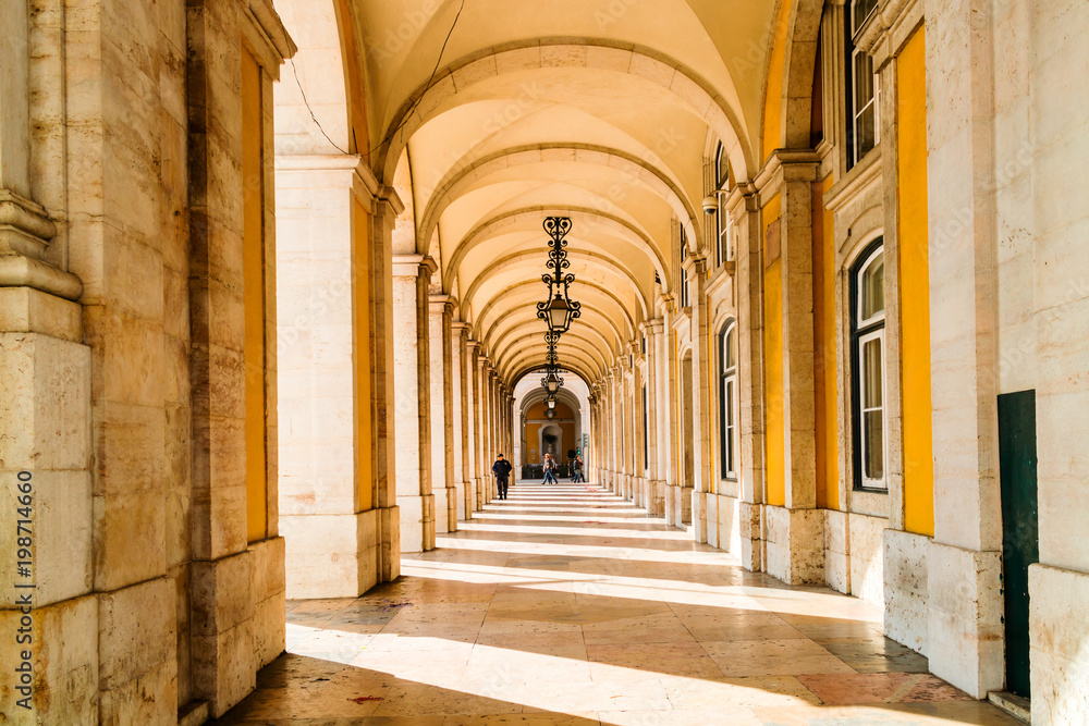 Colonnade and archways under a building in Comercio Square in Lisbon, Portugal.