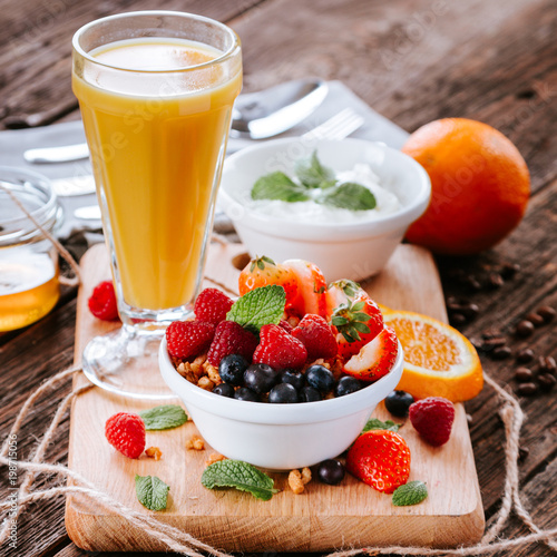 Granola with fruits and orange juice