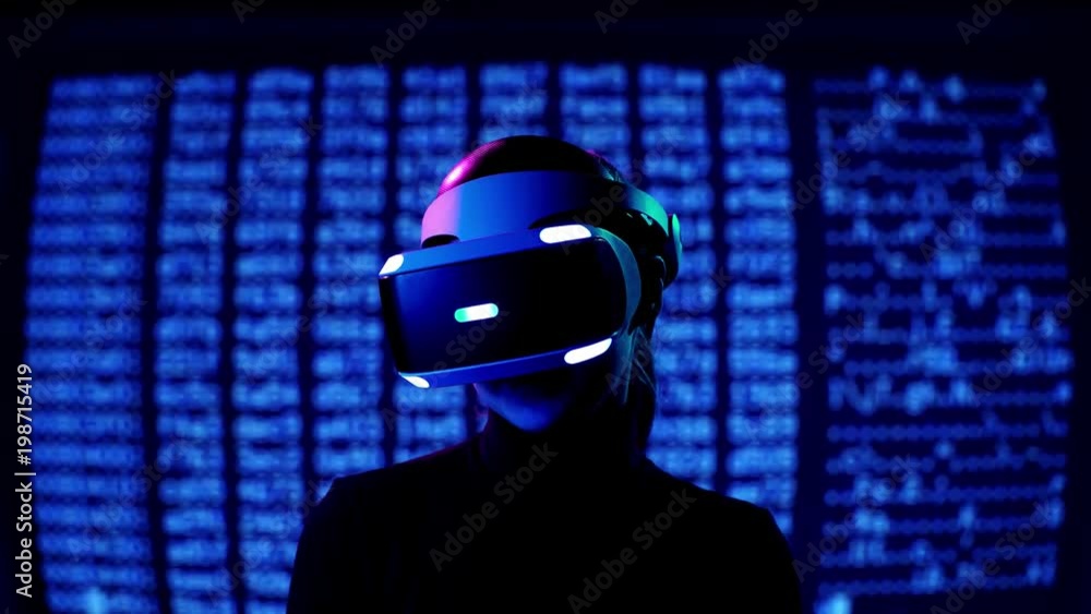 Young woman in VR headset laughs greets and waves her hand and sends air kisses. Virtual reality interactive helmet on brarcode matrix background Young woman in VR headset laughs greets and waves her hand and sends air kisses. Virtual reality interactive helmet on brarcode matrix background